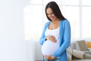 Pregnant woman touching belly