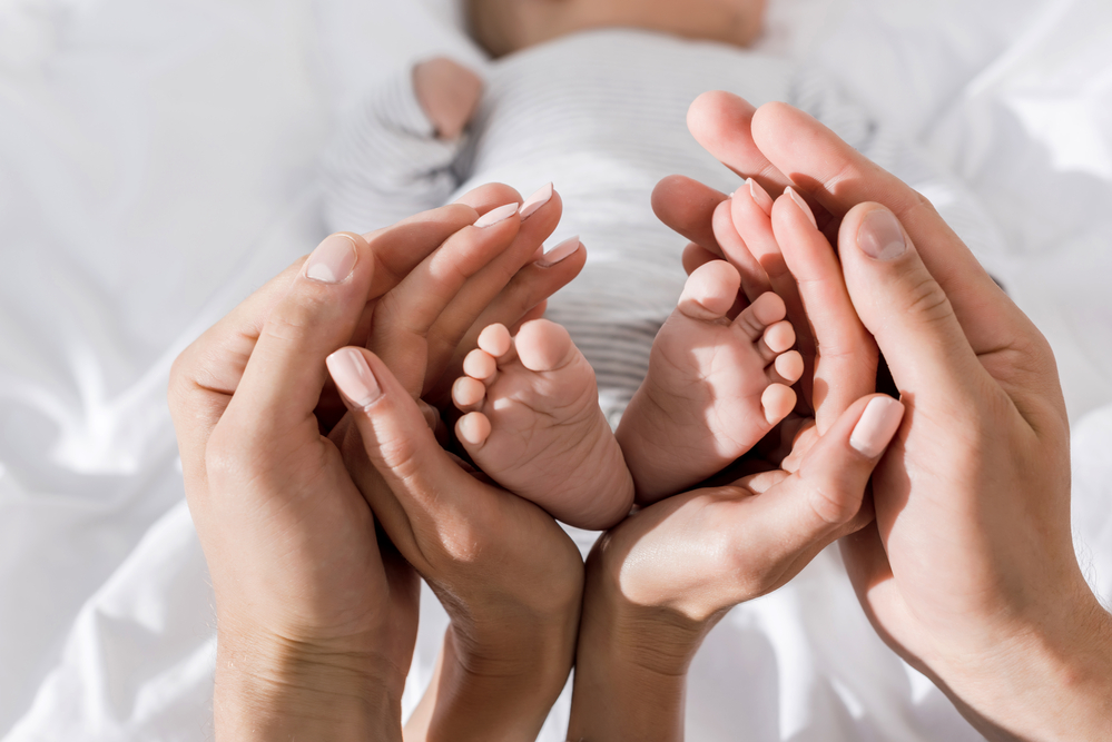 parents and baby born through surrogacy