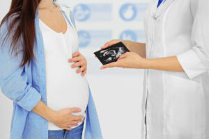 Showing pregnant woman sonogram
