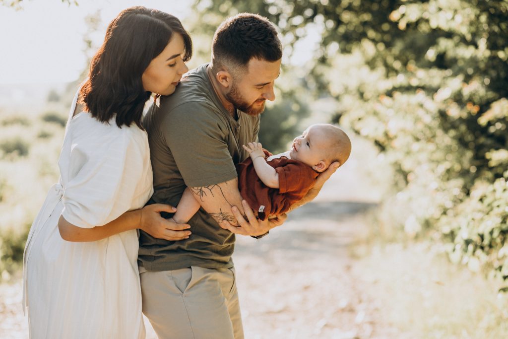 christian couple with baby in park