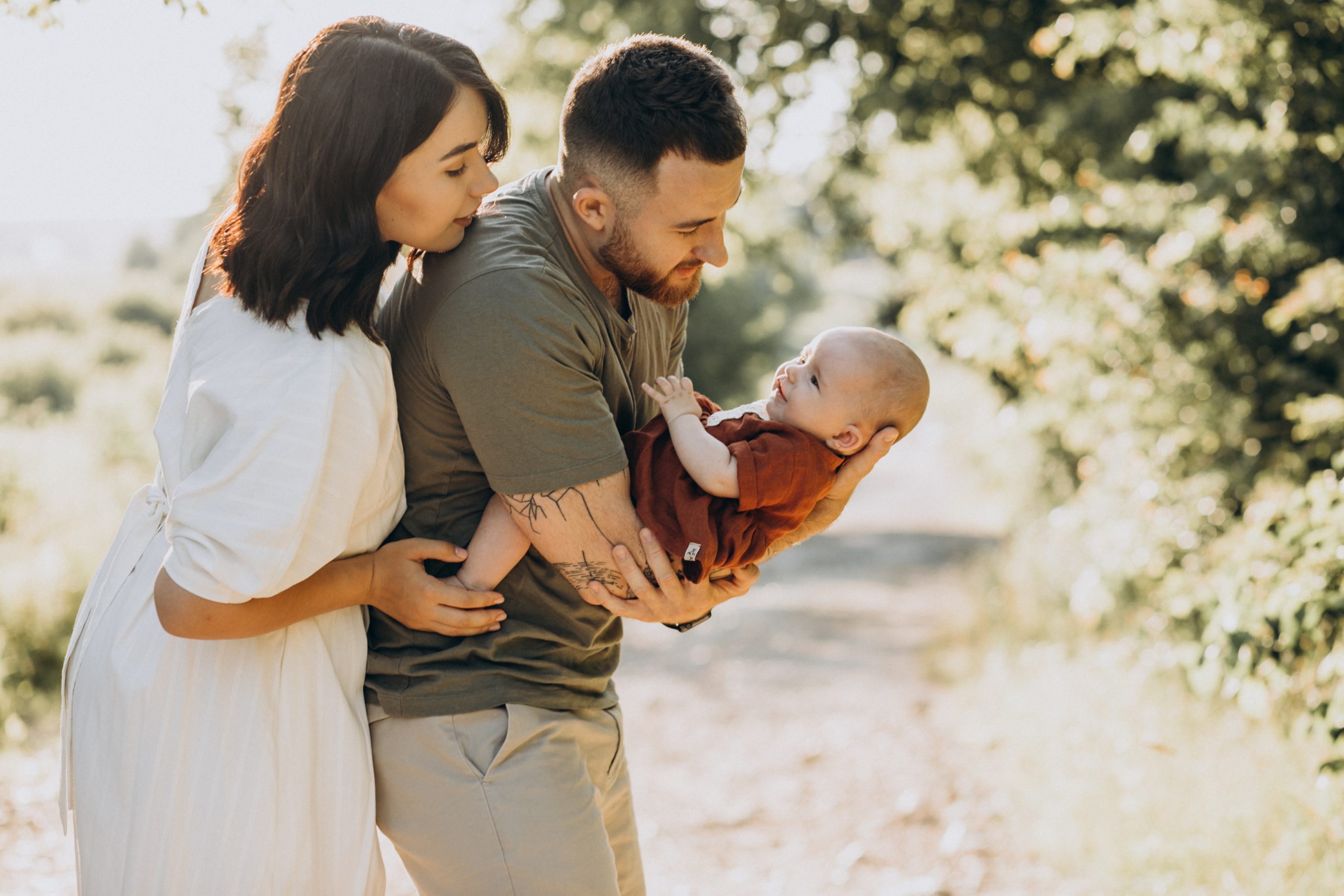 christian couple with baby in park